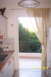 a kitchen with a window with a view of a balcony at Quiet spacious apartment in Nafplio in Nafplio