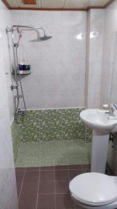 a bathroom with a shower and a toilet and a sink at Gumi A Motel in Gumi