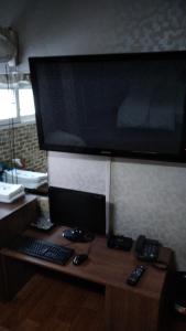 a desk with a computer monitor and a keyboard and mouse at Gumi A Motel in Gumi