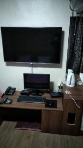 a desk with a laptop computer on top of it at Gumi A Motel in Gumi