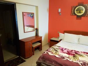 a bedroom with a bed and a dresser and a mirror at Apartment in Porto Sokhna Pyramids for Families in Ain Sokhna +46 photos