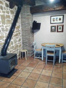 a room with a stove and a table and chairs at Los Masecicos in Mora de Rubielos