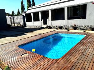 a small swimming pool on a wooden deck at three birds country house in Richmond
