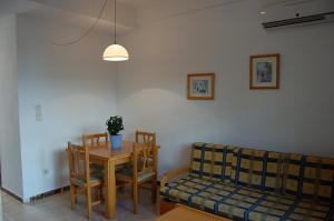 a living room with a table and a couch at Rinconada Real Bungalows- Ap2000 in Benidorm