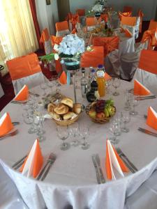 a table with plates of food and wine glasses at Hotel Rares in Botoşani