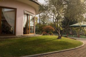 uma casa com um jardim relvado ao lado de um edifício em Albergo Etrusco em Calusco dʼAdda