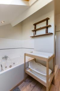 a bathroom with a white tub and a toilet at Le Coeur des Choses in Escalles