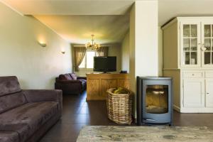 a living room with a couch and a fireplace at Le Coeur des Choses in Escalles