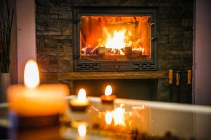 a fireplace with several lit candles in front of it at Divčibarski Vajati in Divčibare