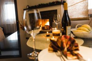 a table with a wine glass and a bottle of wine at Divčibarski Vajati in Divčibare