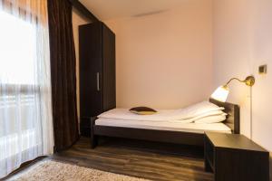 a small bedroom with a bed and a window at Divčibarski Vajati in Divčibare