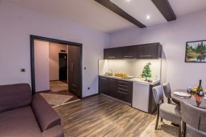 a kitchen with a couch and a table in a room at Divčibarski Vajati in Divčibare