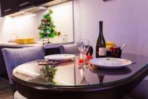a dining room table with a christmas tree in the background at Divčibarski Vajati in Divčibare
