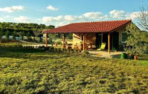 a small house with a red roof in a field at Romantic Villa Cherry in Zadar