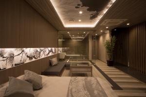 a hotel room with a bed and a couch at WA HOTEL TIMELESS RESORT - Adult Only in Wakayama +99 photos