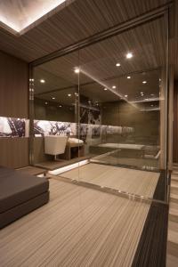 a room with a glass walled bathroom with a couch at WA HOTEL TIMELESS RESORT - Adult Only in Wakayama