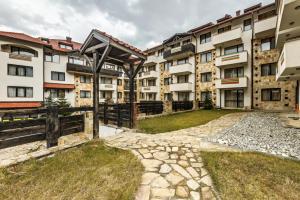 a row of apartment buildings with a yard at Apart Hotel Dream in Bansko