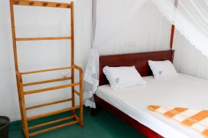 1 dormitorio con 2 camas y escalera en Nature Home, en Mirissa