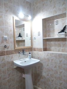 a bathroom with a sink and a mirror at Apartamenty MARINE in Świnoujście