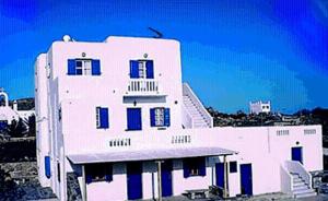a white building with a blue sky at Villa Vasilis in Mikonos