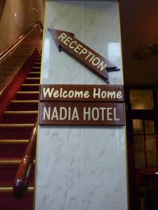 a welcome sign for a hotel in a building at Nadia Hotel in Amsterdam