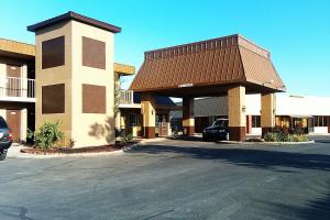 a parking lot in front of a building at Magnuson Hotel Red Baron in Garden City