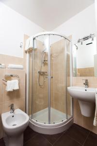a bathroom with a shower and a toilet and a sink at Il Portico Camere e Caffè - centro Città in Savignano sul Rubicone