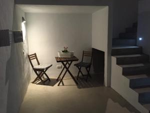 a room with a table and chairs and a staircase at Apartamento Playa Encantador in Puerto del Carmen +1 photo