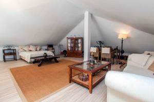 a living room with a couch and a table at Villa Capricho in Marbella +55 photos