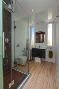 a bathroom with a shower and a toilet and a sink at Villa Capricho in Marbella