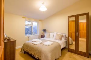 a bedroom with a bed with towels on it at Skyline Serviced Apartments - Colestrete in Stevenage