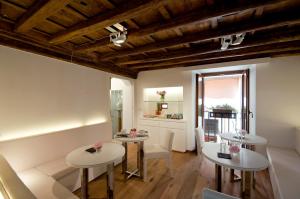 a living room with two tables and a couch at Gigli D'Oro Suite in Rome