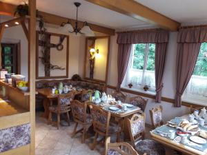 a dining room with wooden tables and chairs at Selský dvůr 1 in Police nad Metují