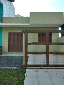a house with a fence in front of it at Casa - Jose Valdemar Americo in Imbé