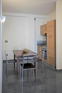 a dining room with a table and chairs in a kitchen at Residence I Gabbiani in Portovenere