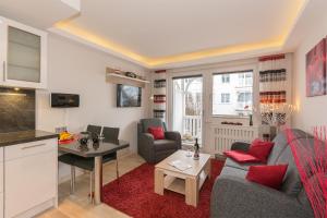 a living room with a couch and a table at Villa Allegra in Binz