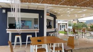 a patio with a bar and tables and chairs at Crystal Blue in Potos
