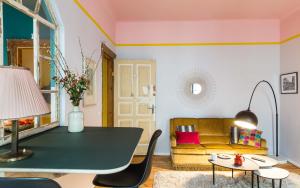 a living room with a table and a couch at Brilliant Apartments in Berlin