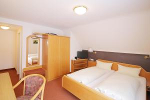 Postel nebo postele na pokoji v ubytování Hotel Platzhirsch
