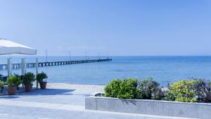 a pier with the ocean in the background at Hotel Avra in Perea +17 photos