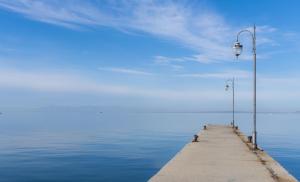 a pier with two lights on the water at Hotel Avra in Perea
