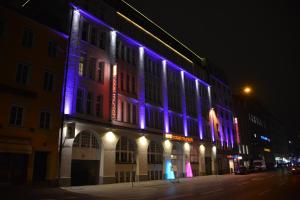 a building with blue and purple lights on it at Arthotel Munich in Munich