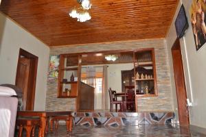 a living room with a table and chairs and a ceiling at Keva Guest House in Kigali