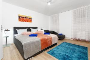 a bedroom with a large bed with a blue rug at BIG Central City Apt. Potsdamer Platz in Berlin