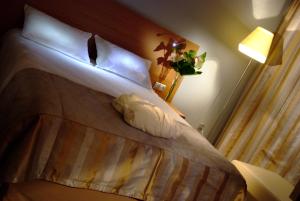Postel nebo postele na pokoji v ubytování Hotel HP Park Poznań Malta