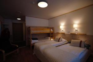 a room with two beds and a chair and lights at Värdshuset Flottaren in Vansbro +33 photos