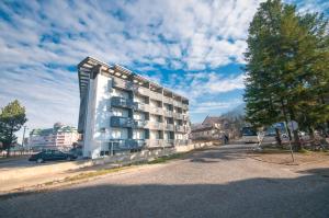 a tall building on the side of a street at Apartmani Stančić in Banja Koviljača