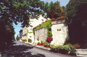 un bâtiment avec des fleurs sur le côté d'une rue dans l'établissement Hotel La Rocca, à Gubbio