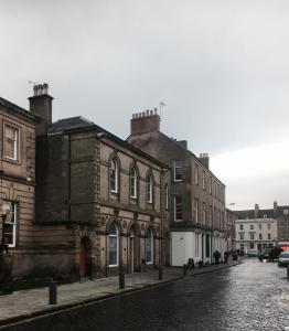 a street with buildings on a cobblestone street at Barclay House in Kelso