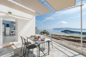 a dining room with a view of the ocean at Kimolia Gi in Kimolos